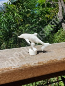 a couple of white statues on a wooden surface 3DPrintCustomz Custom 3D Resin Printing