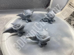 a group of paper models on a table 3DPrintCustomz Custom 3D Resin Printing