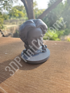 a statue of a head on a wood surface 3DPrintCustomz Custom 3D Resin Printing