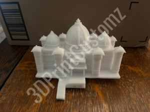 a white toy on a wood floor 3DPrintCustomz Custom 3D Resin Printing