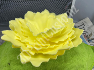 a yellow flower on a green surface 3DPrintCustomz Custom 3D Resin Printing