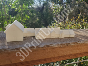 a group of white boxes on a wooden surface 3DPrintCustomz Custom 3D Resin Printing