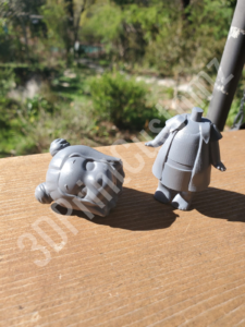 a small figurine on a wood surface 3DPrintCustomz Custom 3D Resin Printing