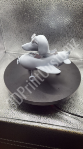 a white toy on a black surface 3DPrintCustomz Custom 3D Resin Printing