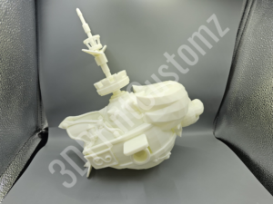 a white toy on a grey surface 3DPrintCustomz Custom 3D Resin Printing